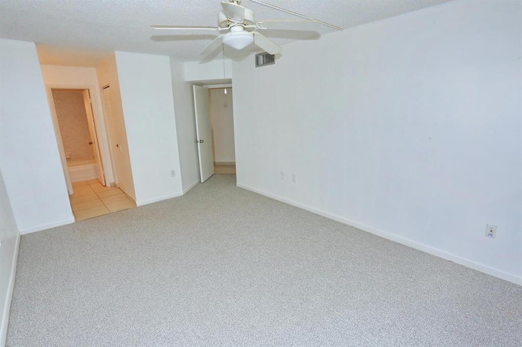 9151 Lime Bay Boulevard, Unit 310 Tamarac, FL 33321 - Photo 23 of 30 wooden floor in an empty room