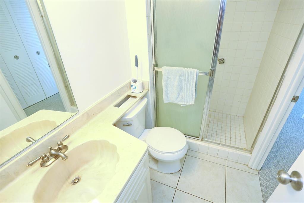 9151 Lime Bay Boulevard, Unit 310 Tamarac, FL 33321 - Photo 24 of 30 a bathroom with a sink and a mirror
