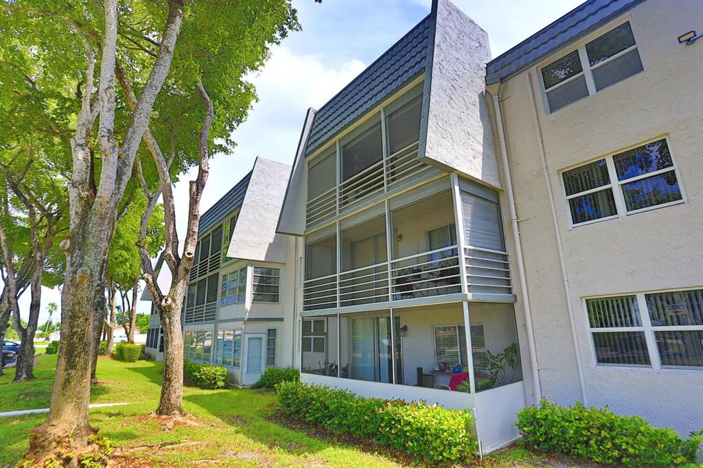 9151 Lime Bay Boulevard, Unit 310 Tamarac, FL 33321 - Photo 28 of 30 a view of a house with a yard and plants
