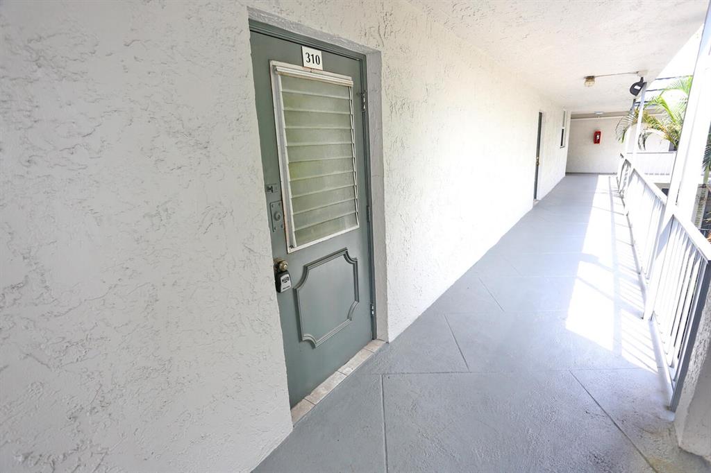 9151 Lime Bay Boulevard, Unit 310 Tamarac, FL 33321 - Photo 5 of 30 a view of hallway with furniture and a gate