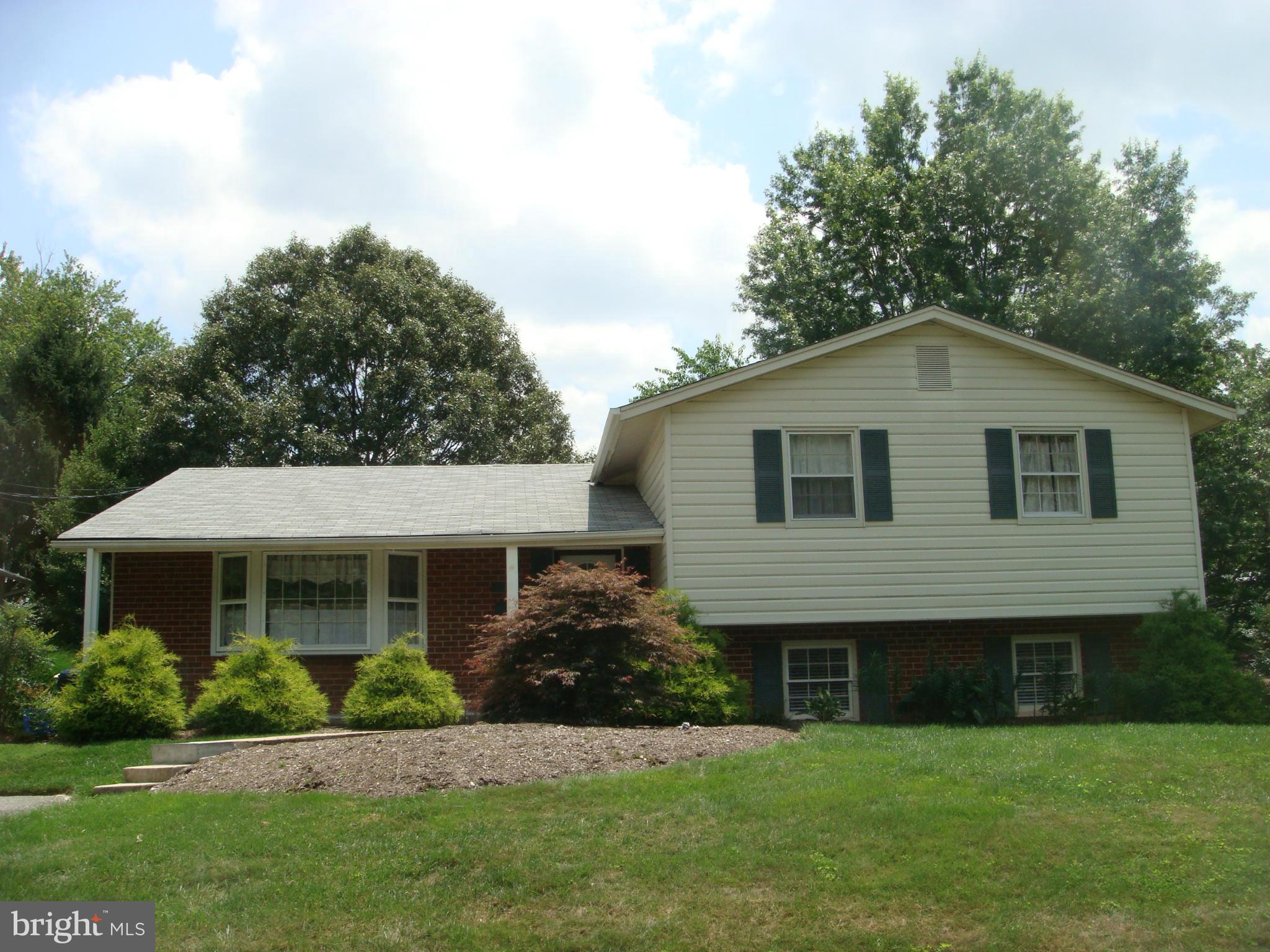 1 Tifton Court Potomac, MD 20854 - Photo 1 of 24 a front view of a house with a yard and trees