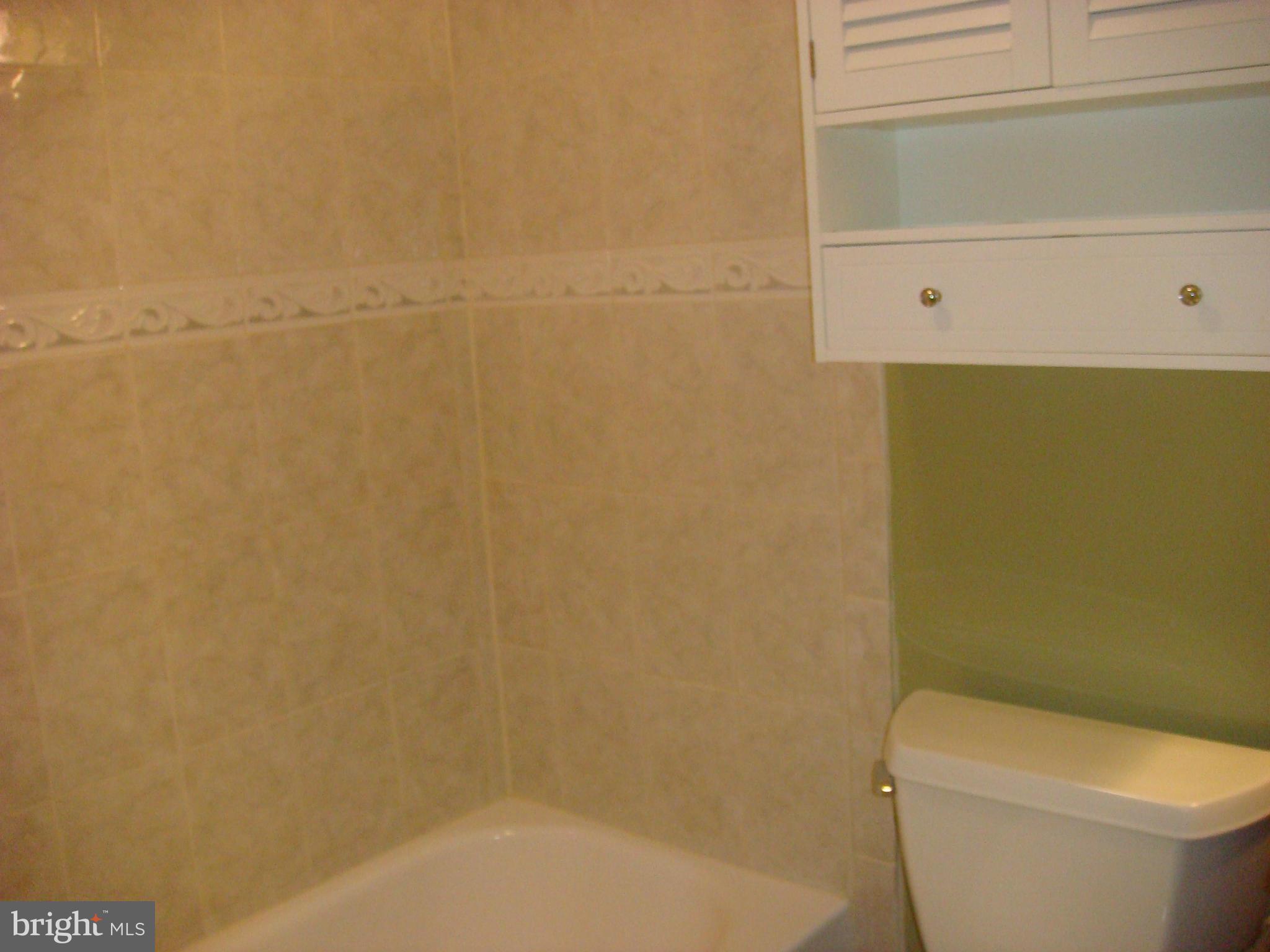 1 Tifton Court Potomac, MD 20854 - Photo 12 of 24 a white toilet sitting next to a shower