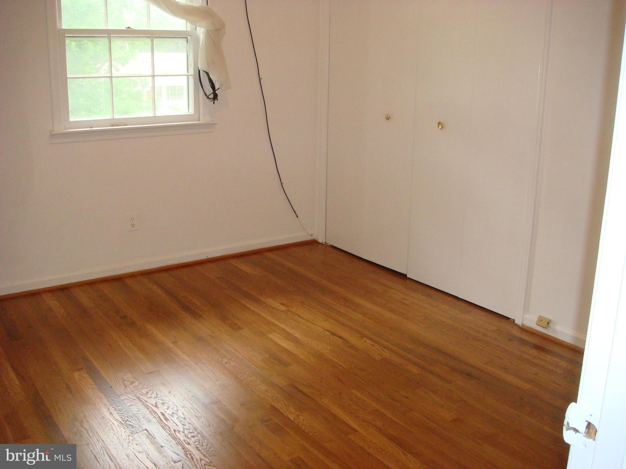 1 Tifton Court Potomac, MD 20854 - Photo 14 of 24 an empty room with wooden floor and windows