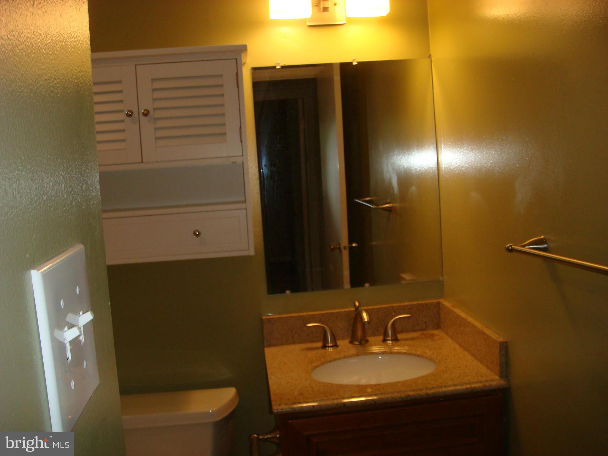 1 Tifton Court Potomac, MD 20854 - Photo 16 of 24 a bathroom with a sink and a mirror