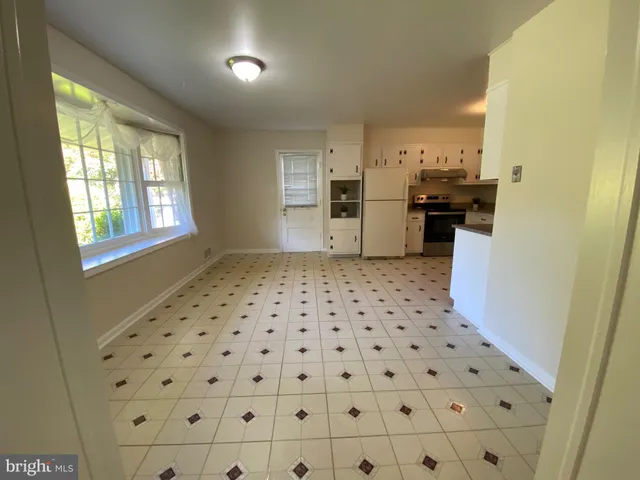 a kitchen with stainless steel appliances a refrigerator sink and cabinets