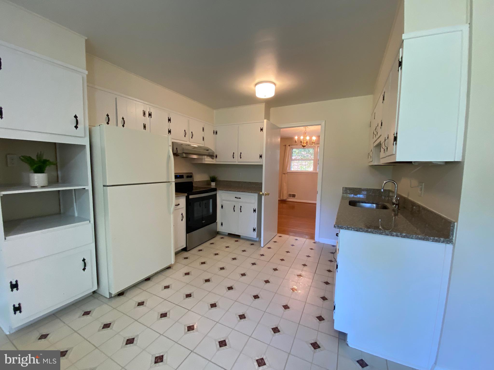 1 Tifton Court Potomac, MD 20854 - Photo 6 of 24 a kitchen with stainless steel appliances a refrigerator sink and cabinets