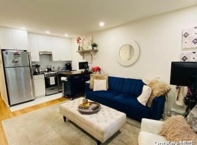 a living room with furniture and a mirror