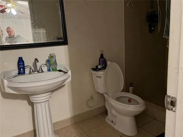 a bathroom with a toilet sink and mirror