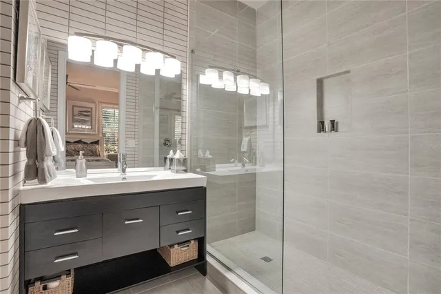 a backyard of a house with fountain table and chairs