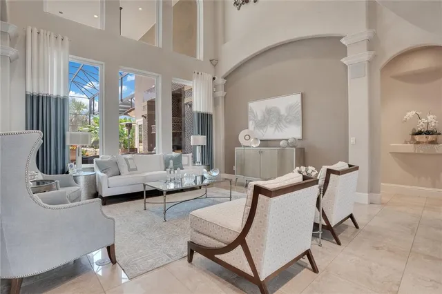 a view of a dining room with furniture and a chandelier