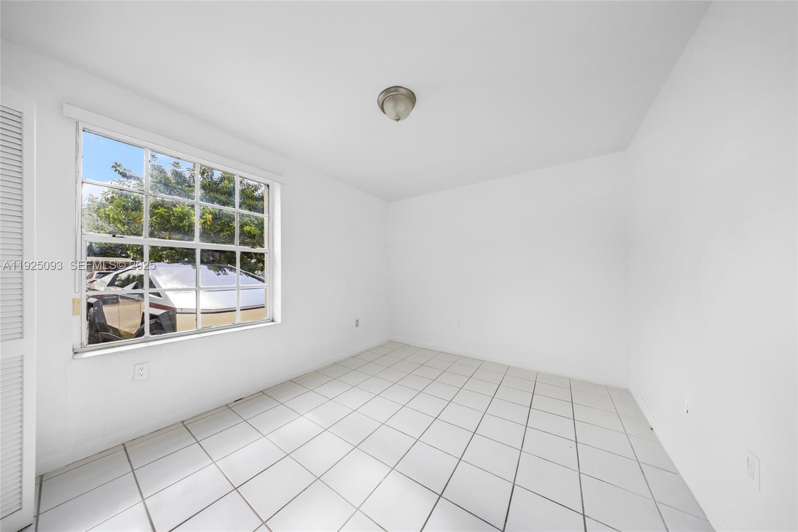 3453 Southwest 23rd Terrace, Unit 1 Miami, FL 33145 - Photo 14 of 22 an empty room with windows