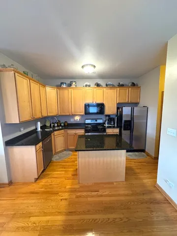 a large white kitchen with wooden floors