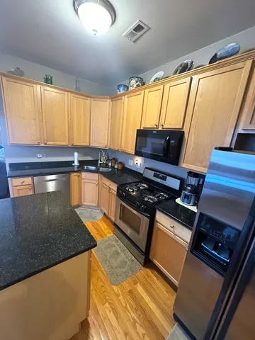 a kitchen with granite countertop a stove and a sink