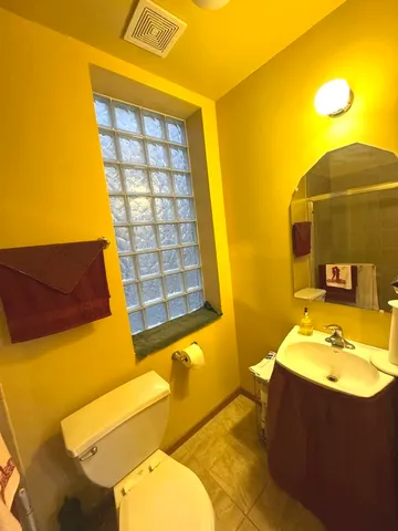 a bathroom with a tub sink and mirror
