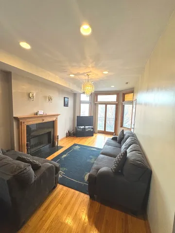 a living room with a bed furniture and a fireplace