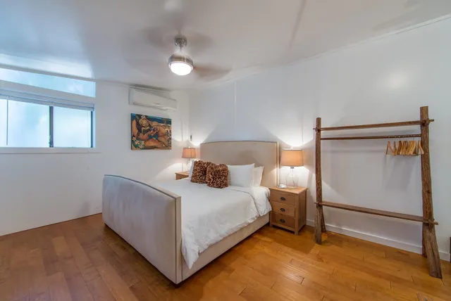 a bedroom with a bed and a night stand