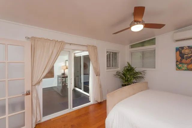 a bedroom with a large bed and a chandelier