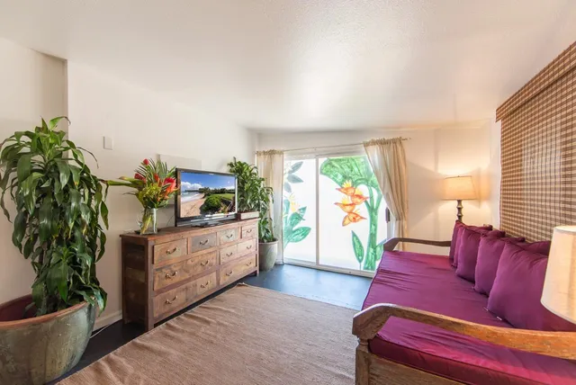 a living room with furniture fireplace and potted plant