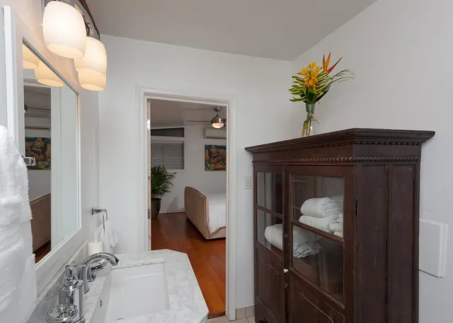 a bedroom with a bed and a mirror