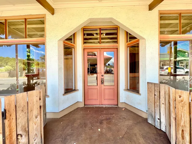 a view of a front door and a car parked front of a house