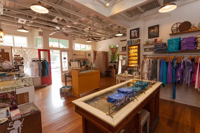 a living room with lots of furniture and kitchen view