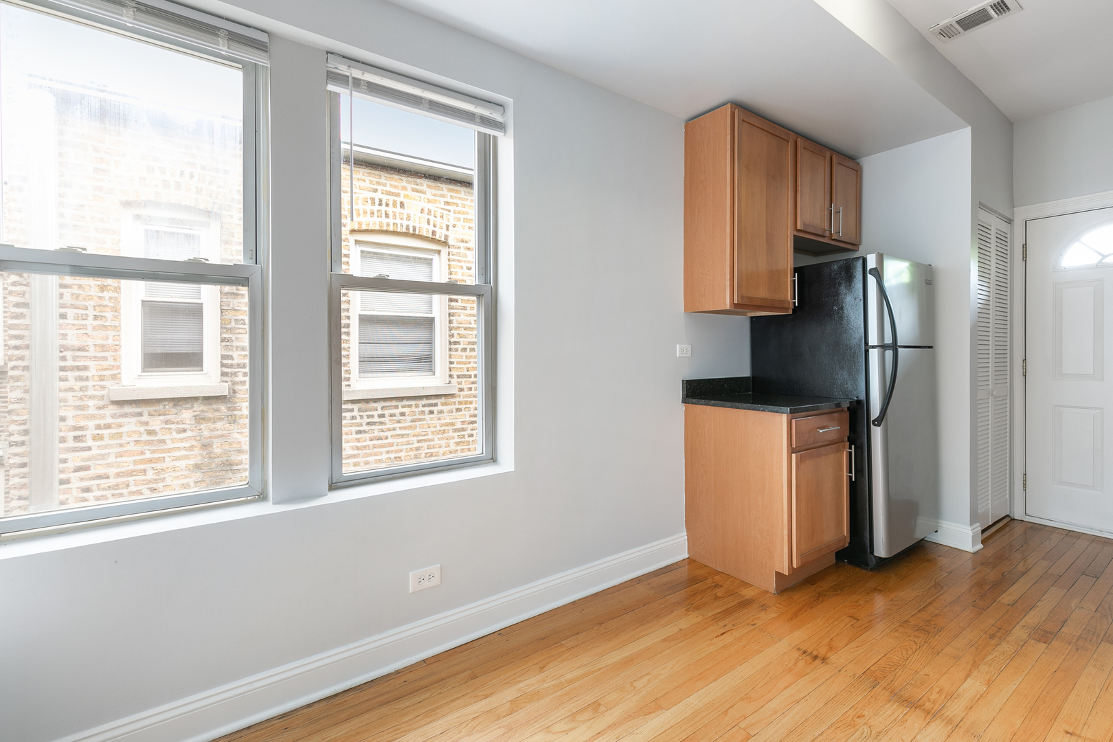 2005 West Jarvis Avenue, Unit 3 Chicago, IL 60645 - Photo 7 of 18 a view of kitchen with furniture refrigerator and window
