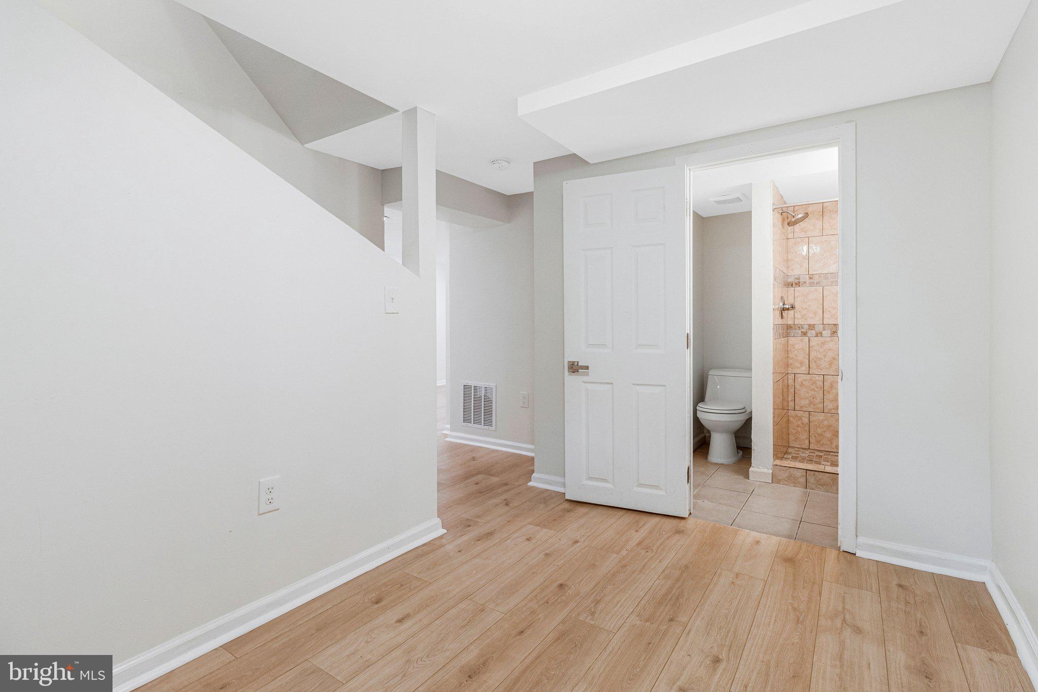 11515 Goodloe Road Silver Spring, MD 20906 - Photo 22 of 33 an empty room with wooden floor