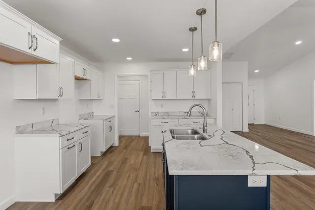 a large kitchen with kitchen island a sink stainless steel appliances and cabinets
