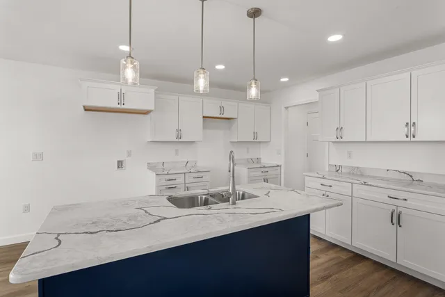 a kitchen with a sink a counter space appliances and cabinets