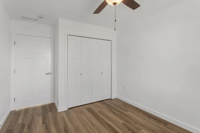 a view of an empty room with a fan