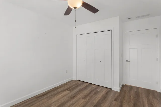 a view of an empty room with a fan