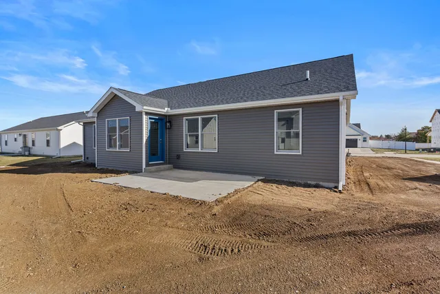 a view of an house with backyard space and wooden fence