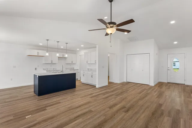 a view of a kitchen with a sink and wooden floor