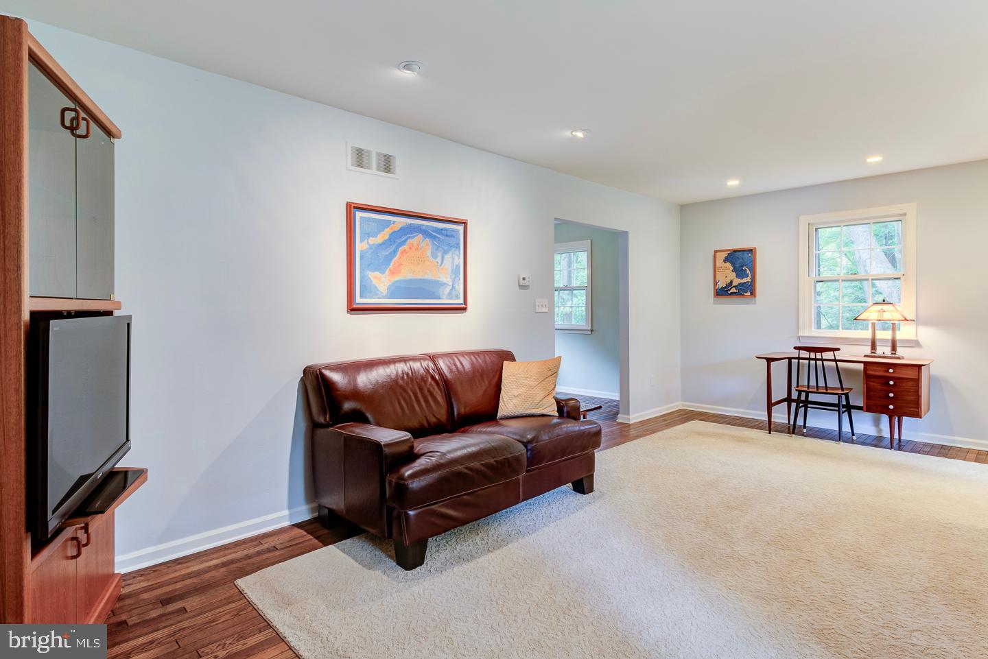 469 Dean Drive Kennett Square, PA 19348 - Photo 11 of 47 a living room with furniture a flat screen tv and a refrigerator