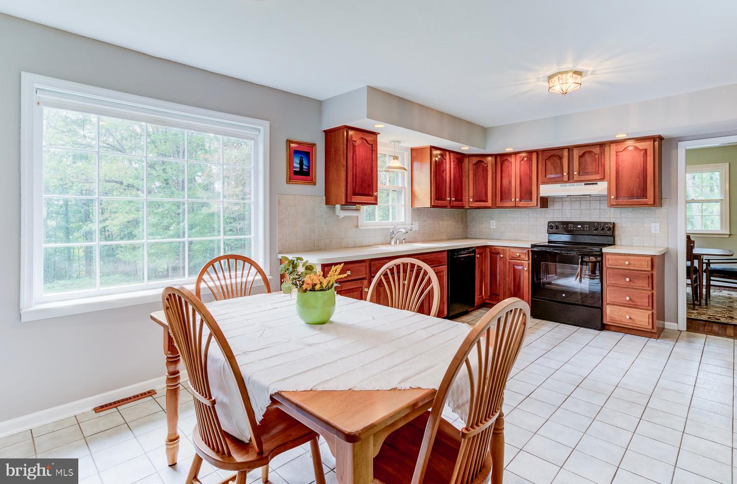 469 Dean Drive Kennett Square, PA 19348 - Photo 17 of 47 a kitchen with stainless steel appliances granite countertop a kitchen island a stove a table and chairs