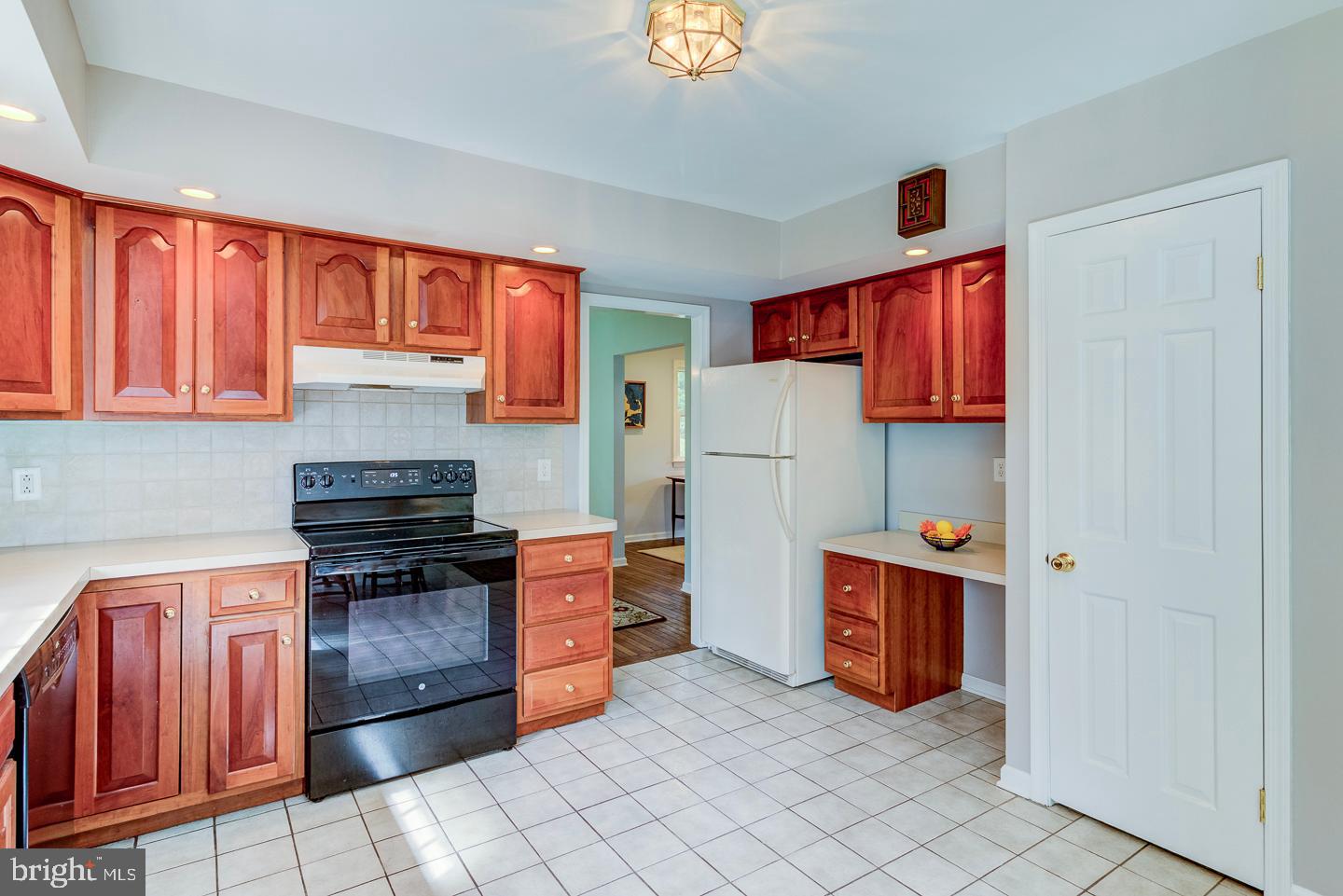 469 Dean Drive Kennett Square, PA 19348 - Photo 19 of 47 a kitchen with stainless steel appliances a stove top oven a sink and a refrigerator