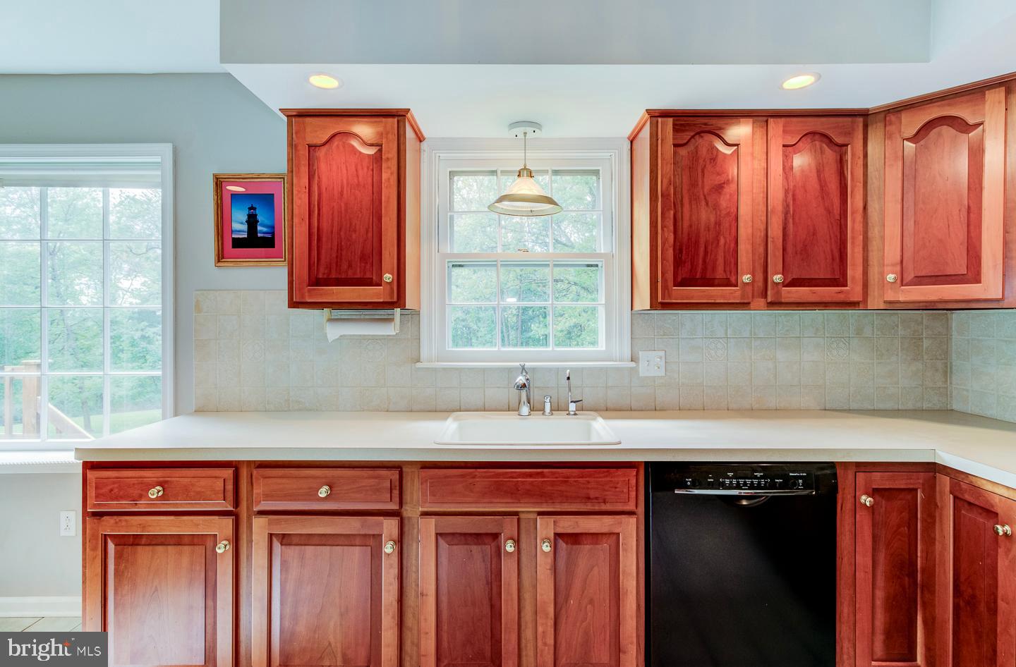 469 Dean Drive Kennett Square, PA 19348 - Photo 20 of 47 a kitchen with stainless steel appliances granite countertop wooden cabinets a sink and a window