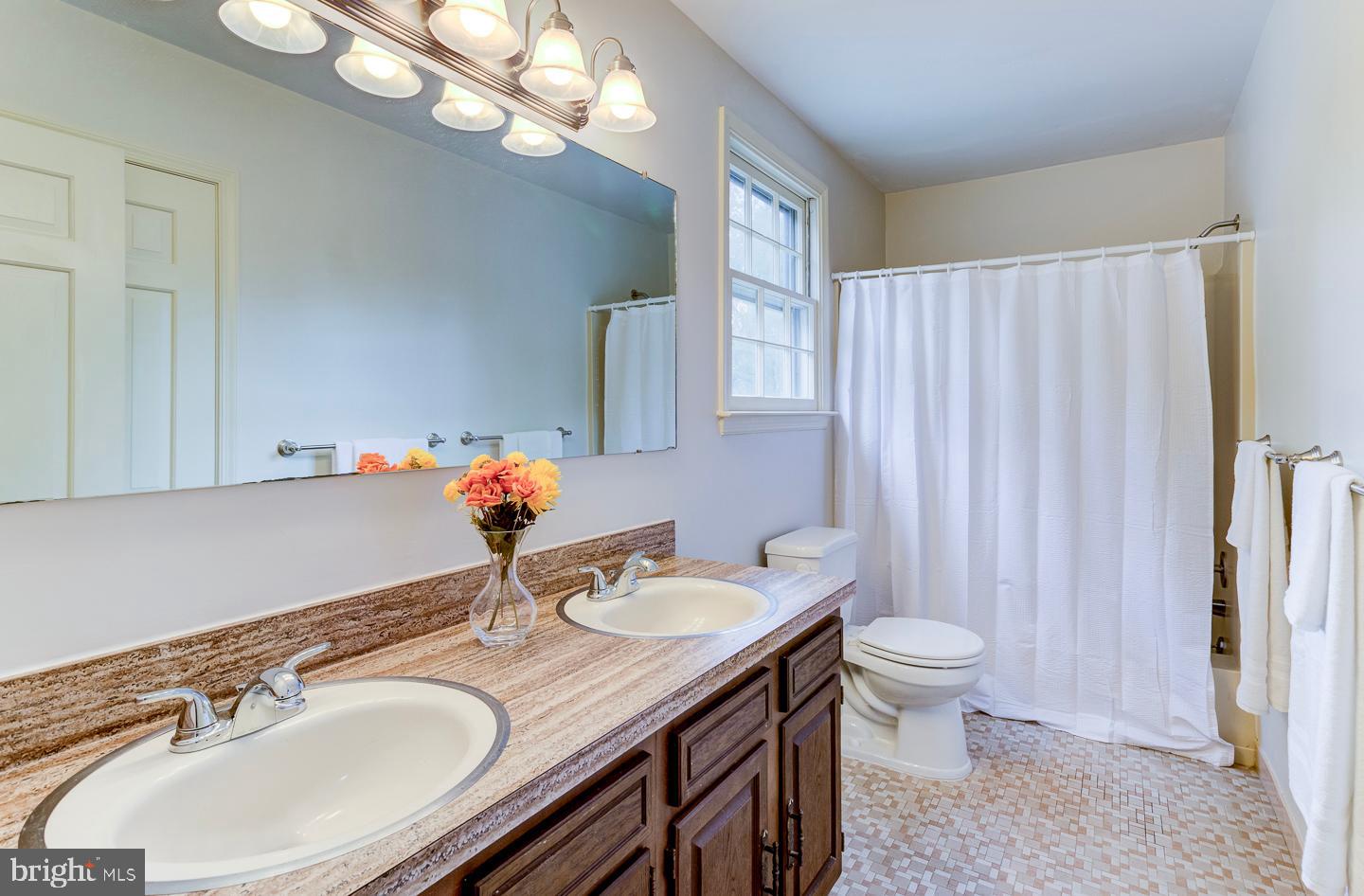 469 Dean Drive Kennett Square, PA 19348 - Photo 39 of 47 a bathroom with a granite countertop sink a toilet and a mirror