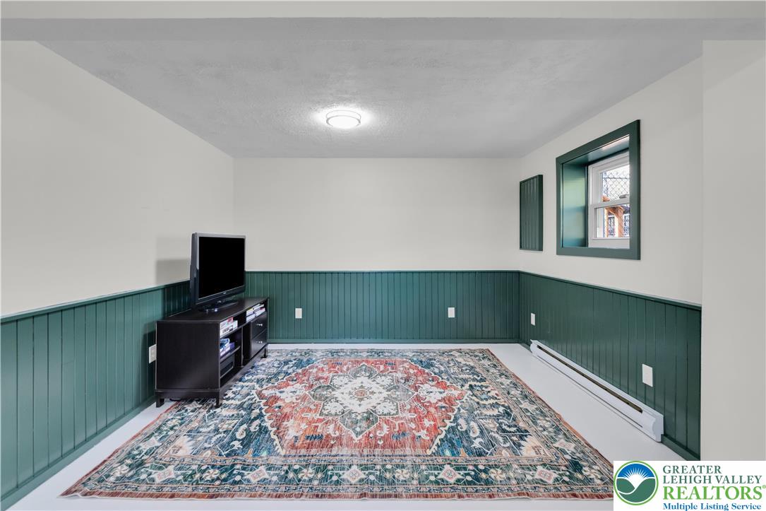 107 Shenkel Road Effort, PA 18330 - Photo 32 of 44 a living room with a flat screen tv and a rug