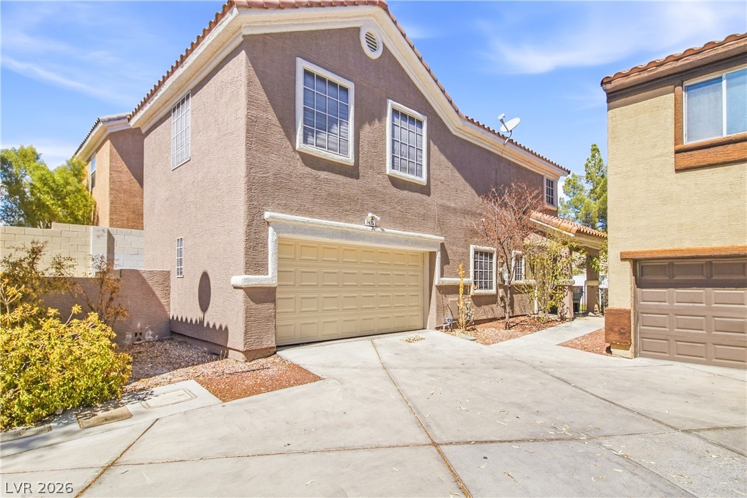 1475 Reef Ridge Court Las Vegas, NV 89128 - Photo 2 of 24 Spanish tile roofing and classic stucco exterior define this welcoming multi-level home.