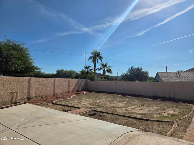 a view of a house with a backyard