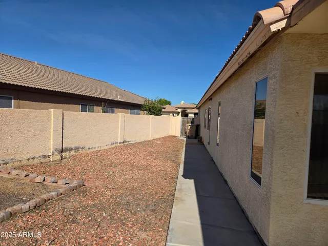 a view of a house with a backyard