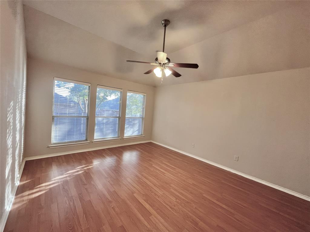 4808 Heber Springs Trail Fort Worth, TX 76244 - Photo 8 of 16 a view of an empty room with wooden floor and a window