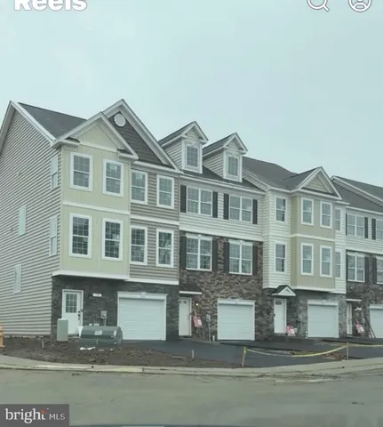 a front view of a residential apartment building with a yard
