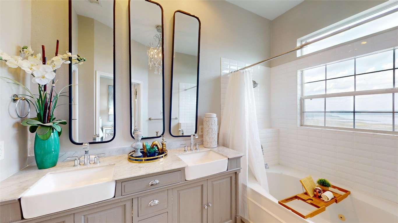 2918 Ranch Road 620, Unit 297 Austin, TX 78734 - Photo 11 of 37 Bathroom featuring double vanity and shower / bath combo with shower curtain