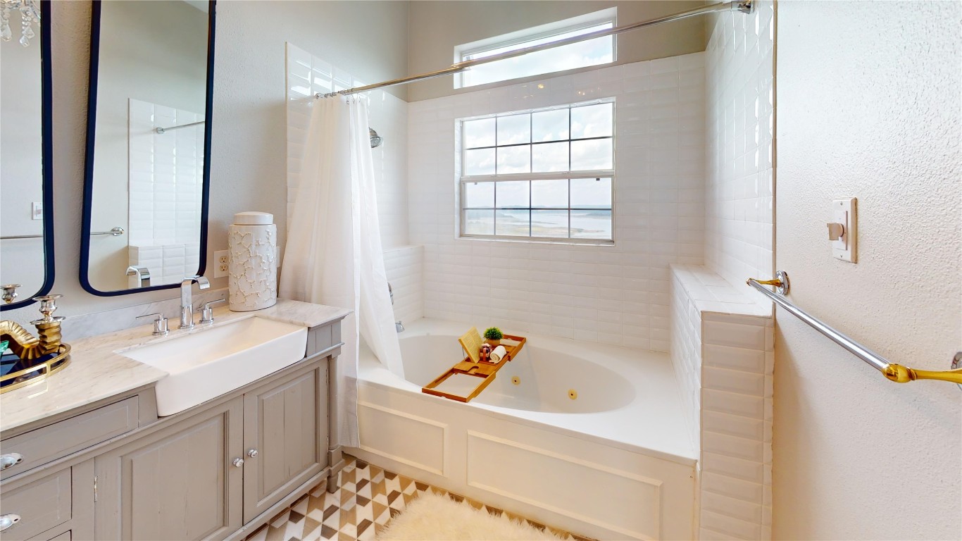 2918 Ranch Road 620, Unit 297 Austin, TX 78734 - Photo 12 of 37 Full bath featuring vanity, a combined bath / shower with jetted tub, and a textured wall