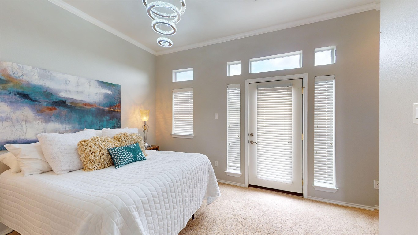 2918 Ranch Road 620, Unit 297 Austin, TX 78734 - Photo 13 of 37 Carpeted bedroom featuring crown molding and a chandelier
