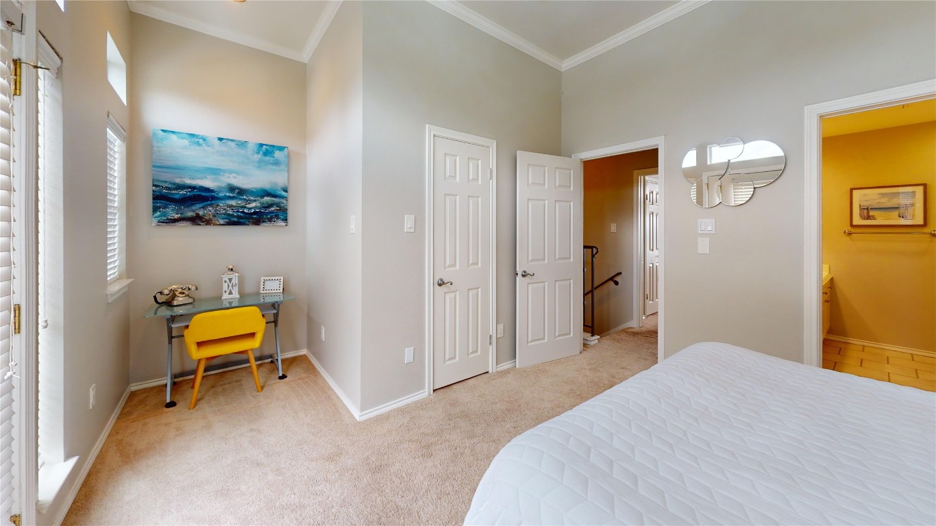 2918 Ranch Road 620, Unit 297 Austin, TX 78734 - Photo 14 of 37 Bedroom with crown molding and light colored carpet