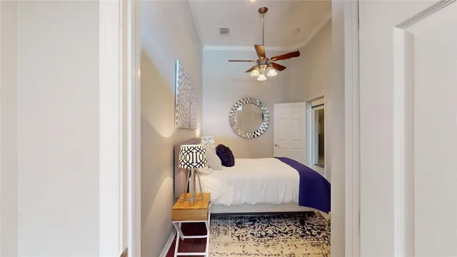 a bedroom with a bed and a chandelier