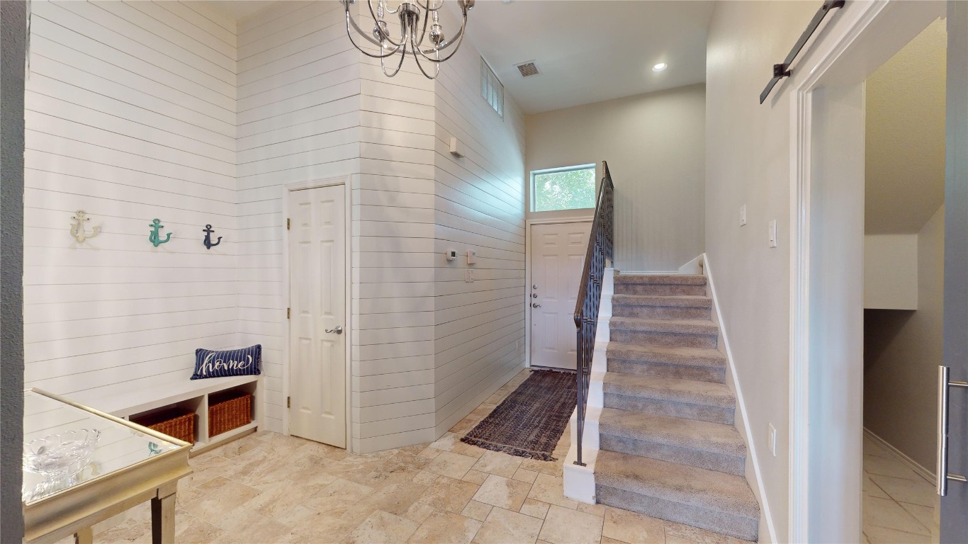 2918 Ranch Road 620, Unit 297 Austin, TX 78734 - Photo 21 of 37 Stairway featuring a chandelier, recessed lighting, and stone finish floors